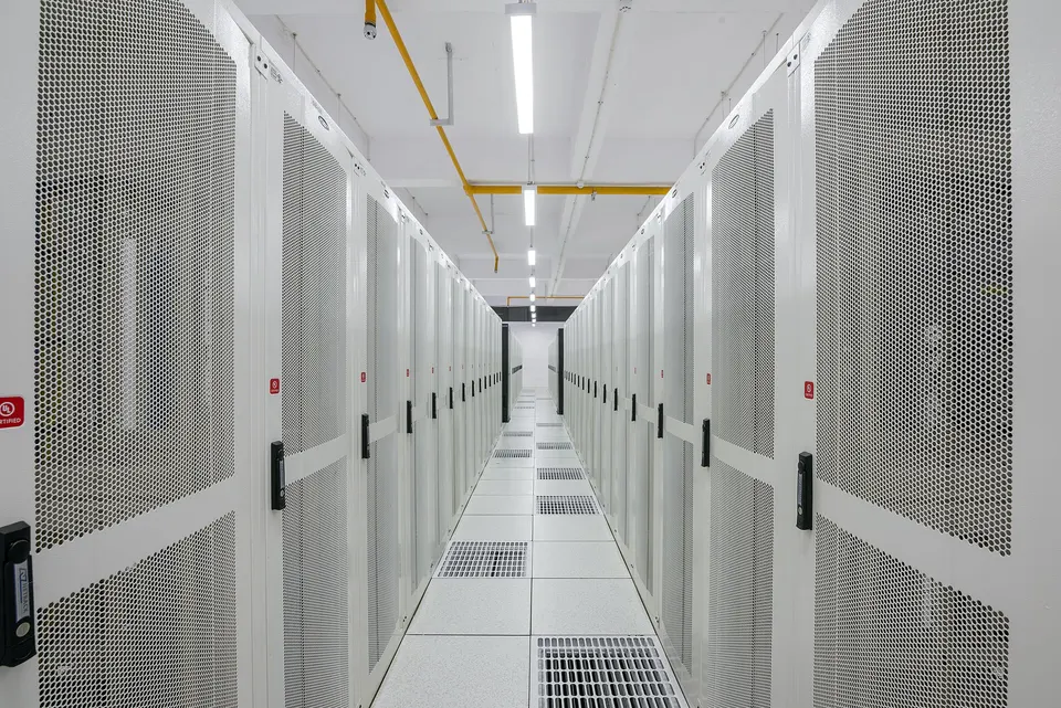 Data centre aisle between rows of server cabinets