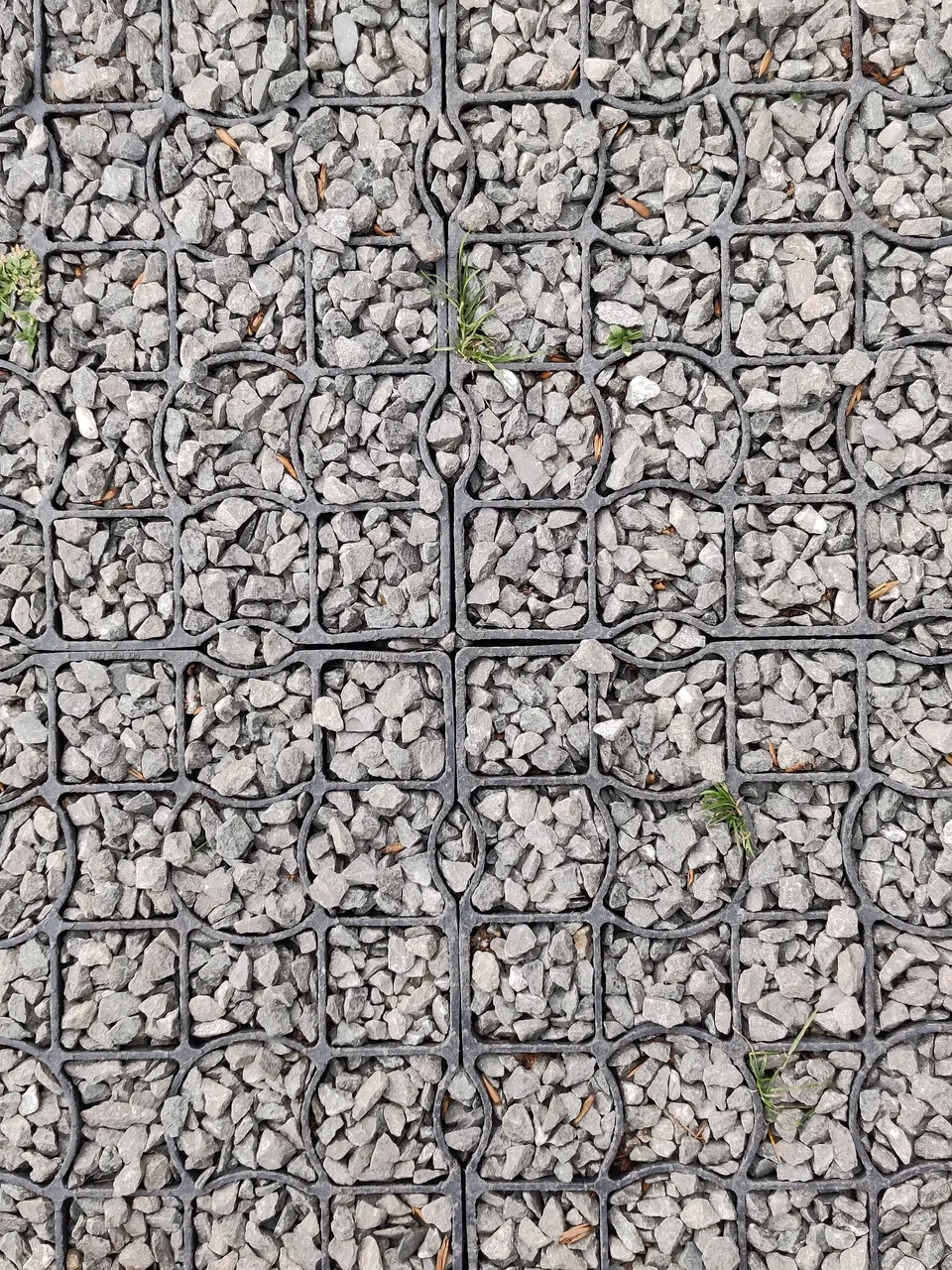 Plastic gravel grid filled with angular aggregate