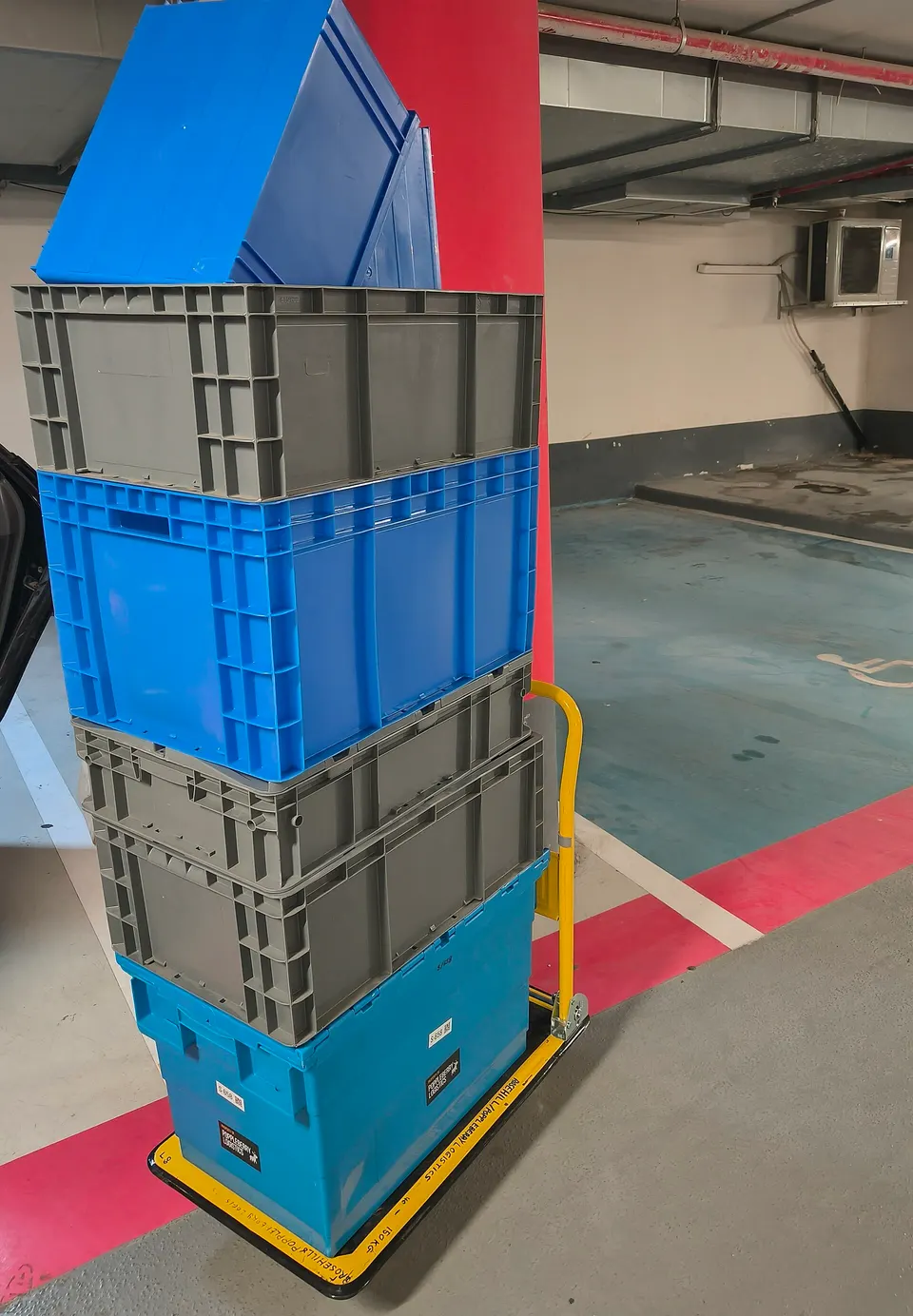 Blue and grey small load carriers in a stack