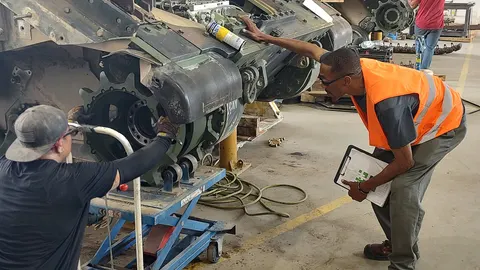 Inspector recording findings during an equipment inspection