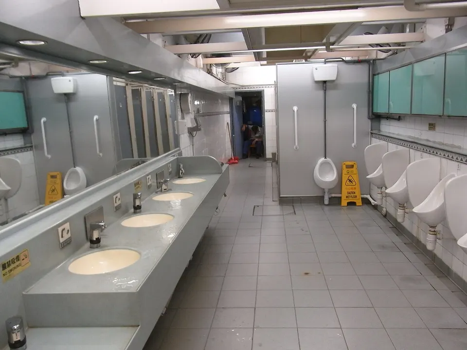Public washroom with urinals and cubicles