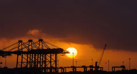 Container terminal cranes at sunset